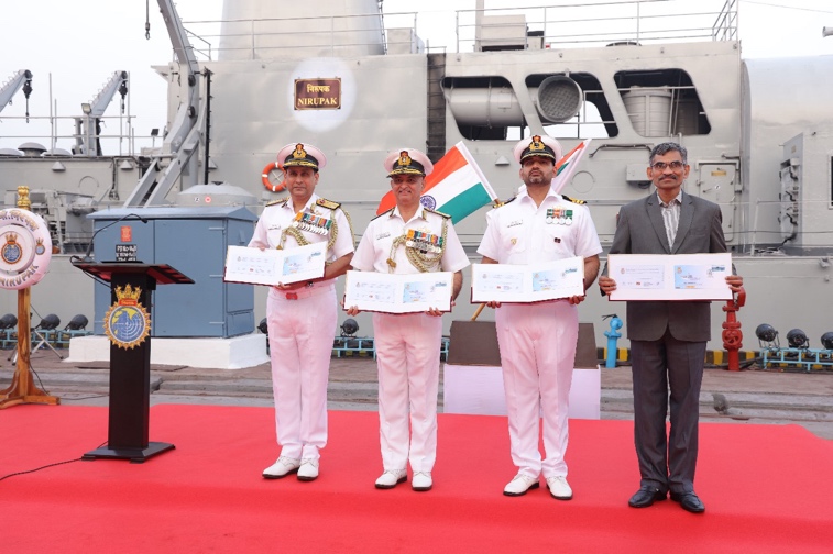 A group of men in uniform holding certificates Description automatically generated